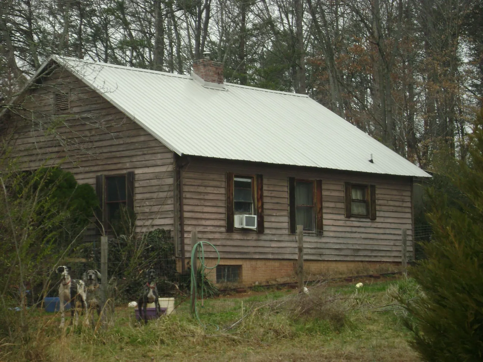 White metal roof on an old wood sided farmhouse, from a Metal Roof Installation job in Woodberry Forest